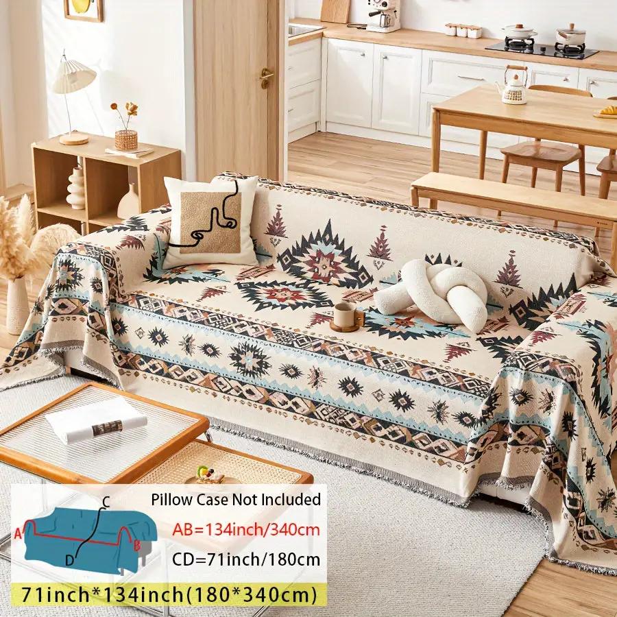 Extra Large sofa cover – stretchable furniture protector in beige with blue geometric pattern on a sofa.