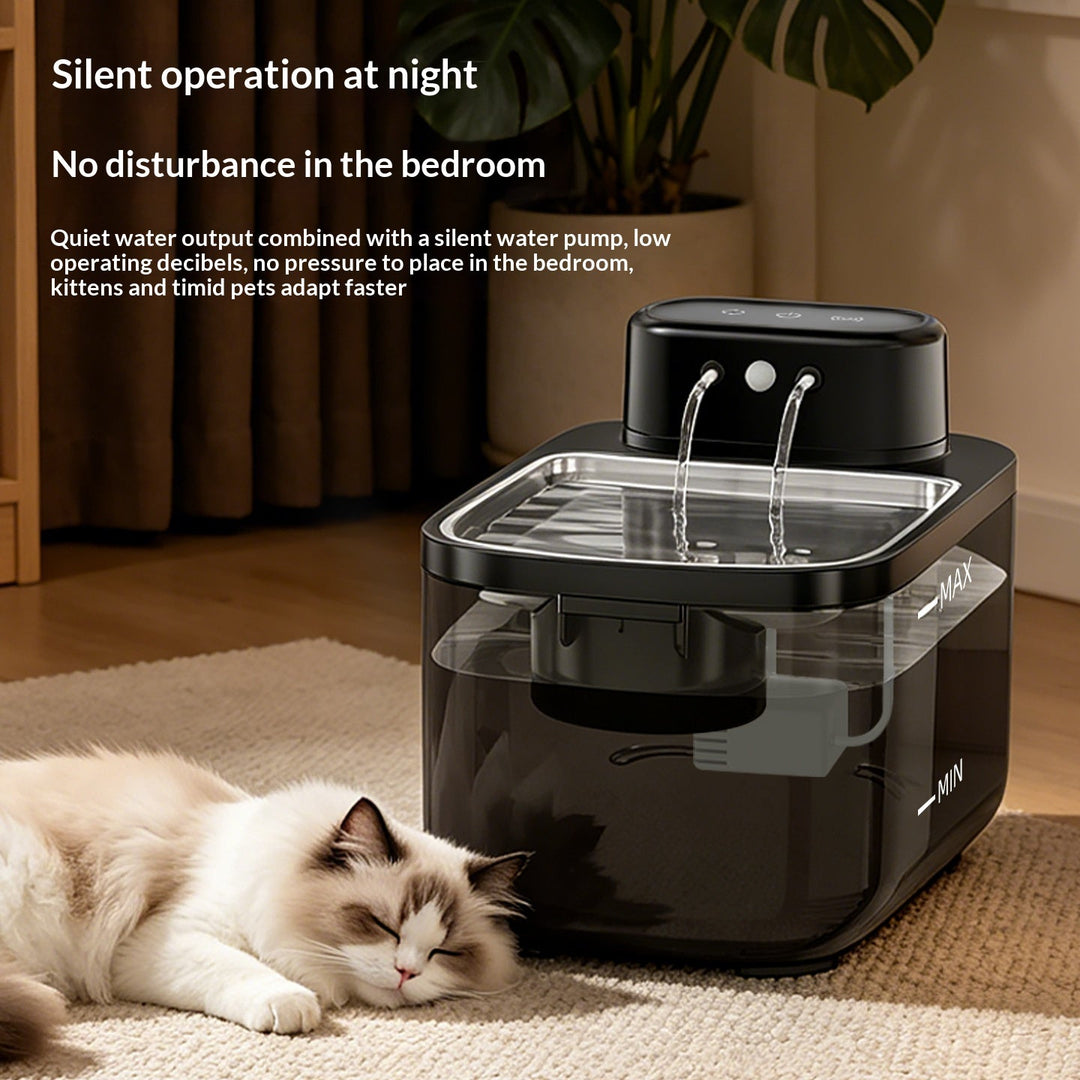 Black twin-stream fountain beside a resting cat