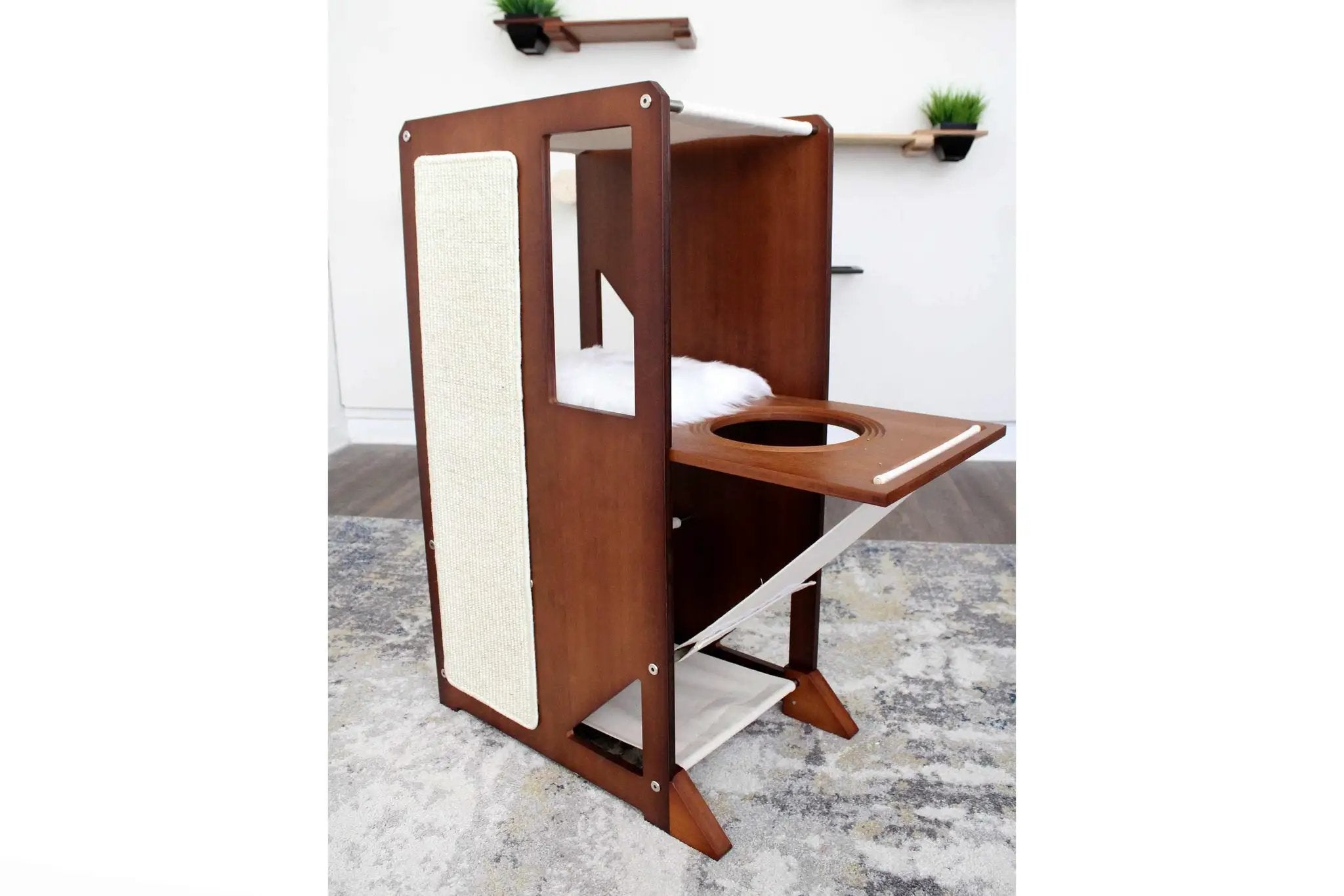 The Overlook bamboo cat condo; brown wooden cat tree with sisal panel and cozy white bed.