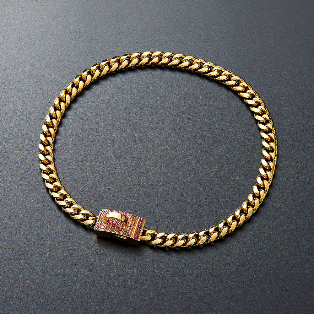 Gold-tone chain collar with pink-accented clasp