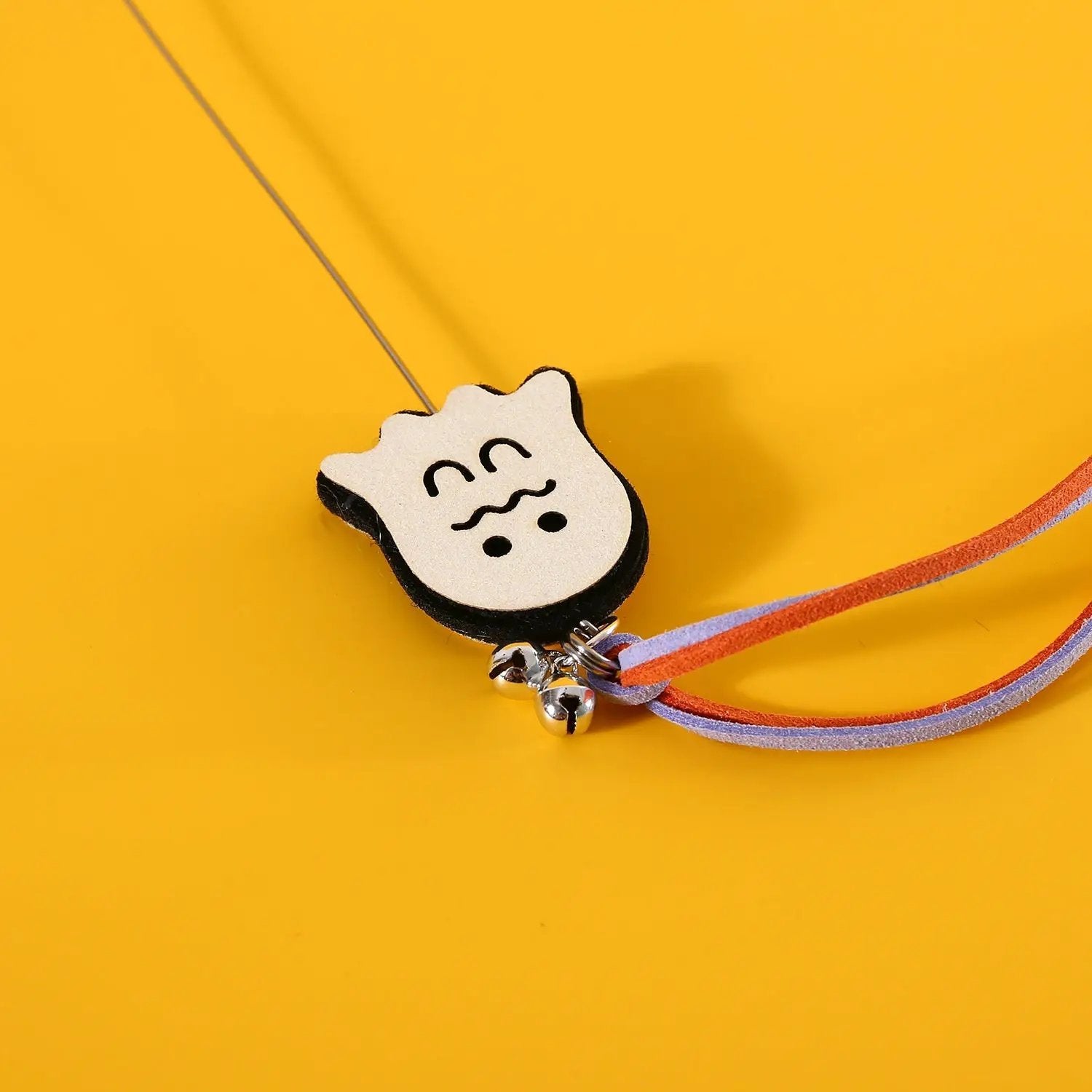 Pet Zen Halloween Cat Teaser sounding bell toy for cats; white cat-face foam with bells and orange-purple straps.