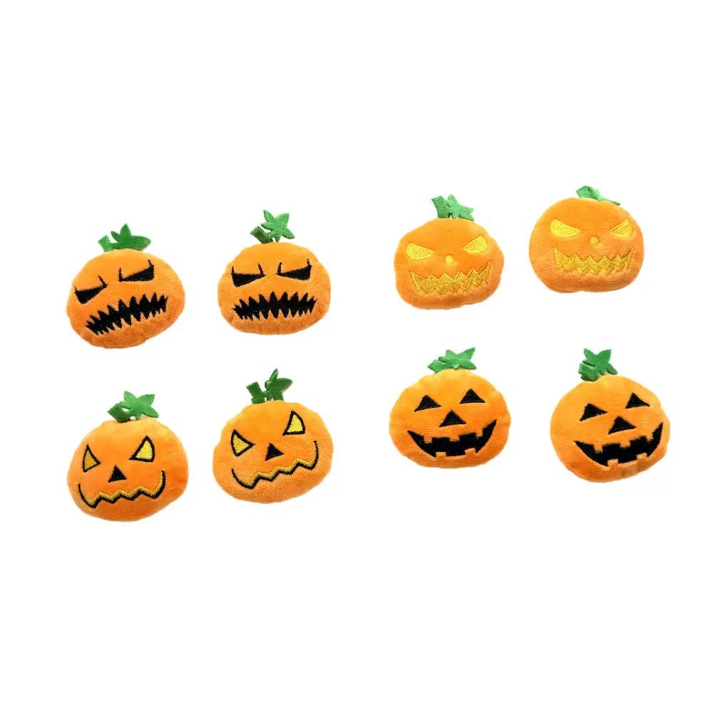 Eight orange pumpkin plush toys with green stems and embroidered jack-o-lantern faces for a Halloween-themed pet toy set