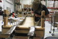 Load image into Gallery viewer, Cat Bridge for Wall wooden cat perch under assembly in a workshop
