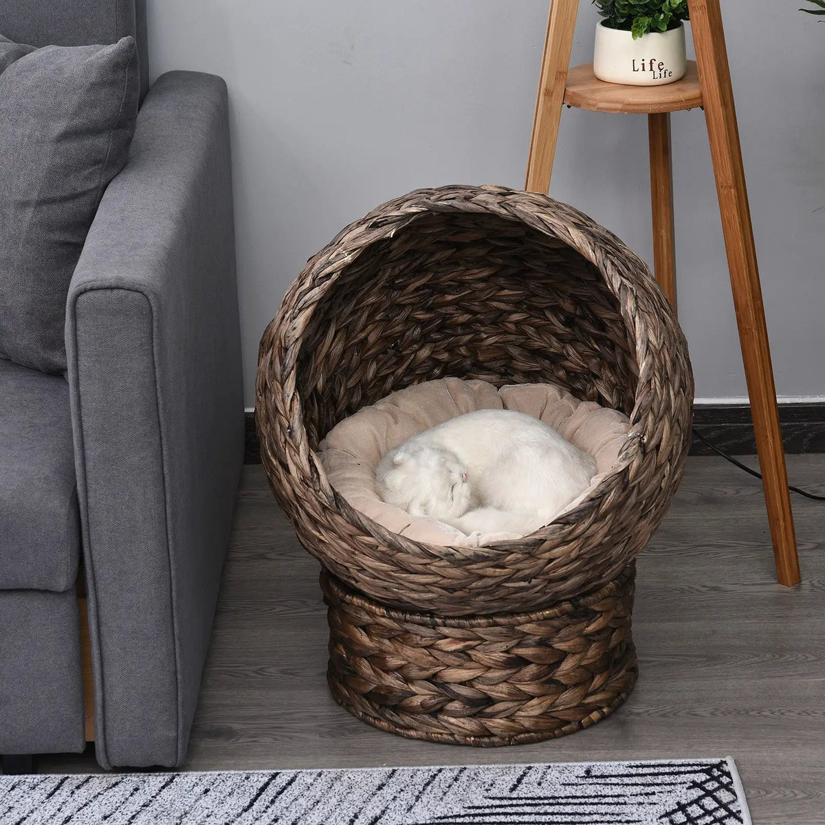 Handmade round wicker cat bed with beige cushion in dark brown for kittens