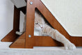 Charger l'image dans la visionneuse de la galerie, The Overlook bamboo cat condo; sturdy wooden frame with a triangular opening and a cat lounging inside.
