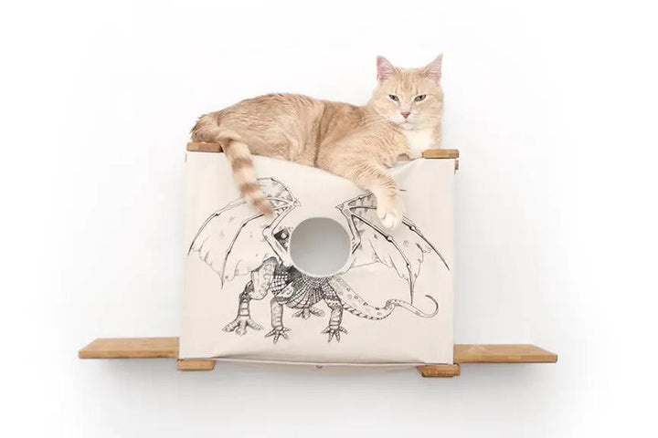 Cat Cubby for Wall - Covered Cat Bed by Catastrophic Creations; beige fabric cube with circular entry on wood shelves, cat lounging.