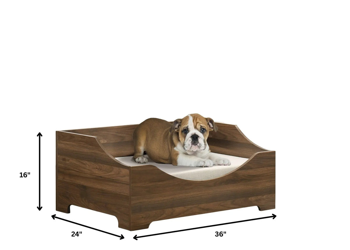 Gibson 36-inch Pet Bed by Home Furnishers; wood-grain bed with curved front entry and beige cushion.