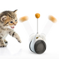 Bild in Galerie-Betrachter laden, Cat beside the black-and-white Orbit Wobble Cat Toy, with motion trails illustrating the ball swinging side to side
