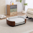 Load image into Gallery viewer, Scandinavian style elevated dog bed with solid wood legs and light gray cushion in a modern living room.
