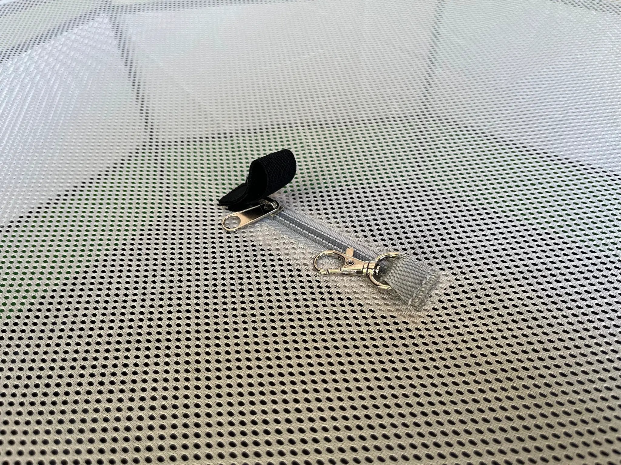 Hen Pen Deluxe Pop-Up Chick Brooder on a perforated metal surface with a black strap and metal clips
