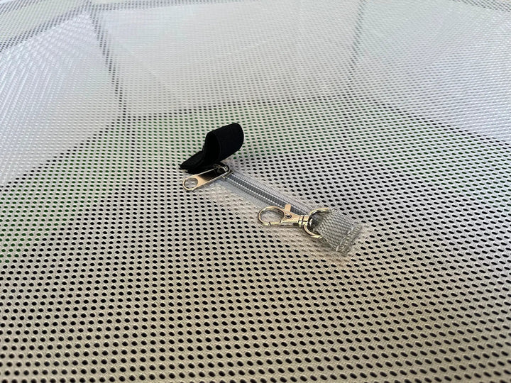 Hen Pen Deluxe Pop-Up Chick Brooder on a perforated metal surface with a black strap and metal clips