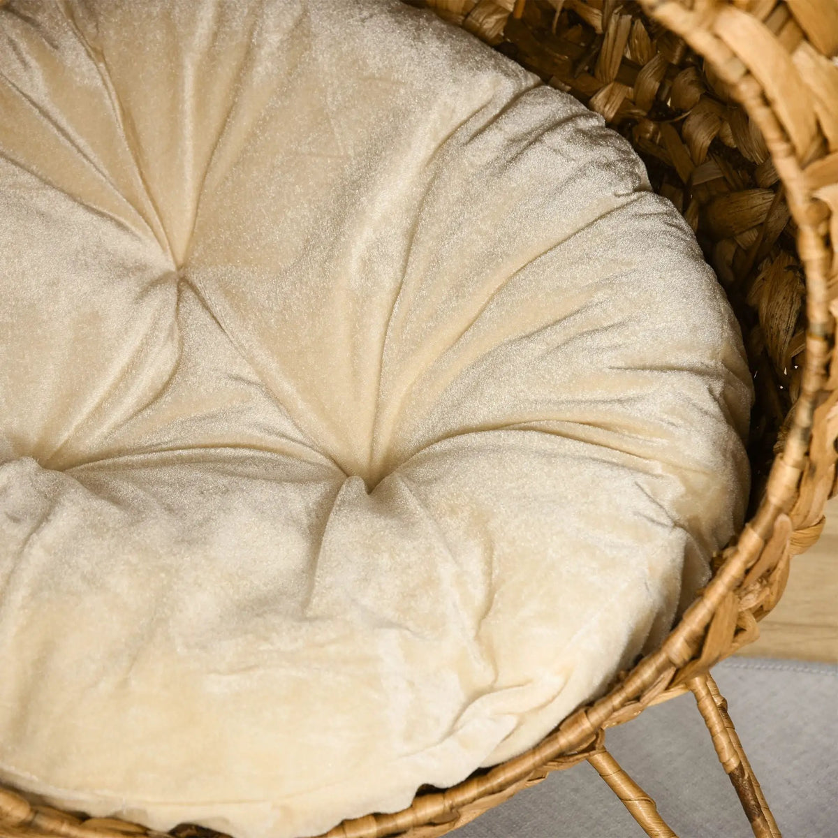 Cozy Elevated Cat Bed in brown with a woven basket frame and soft cushion by Doba