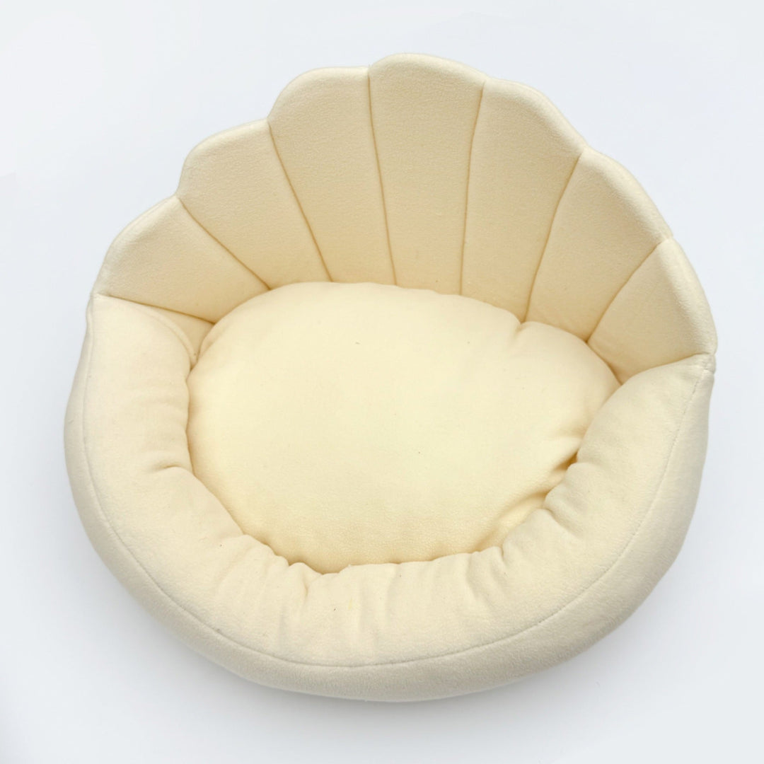 Beige scallop-back pet sofa on white background