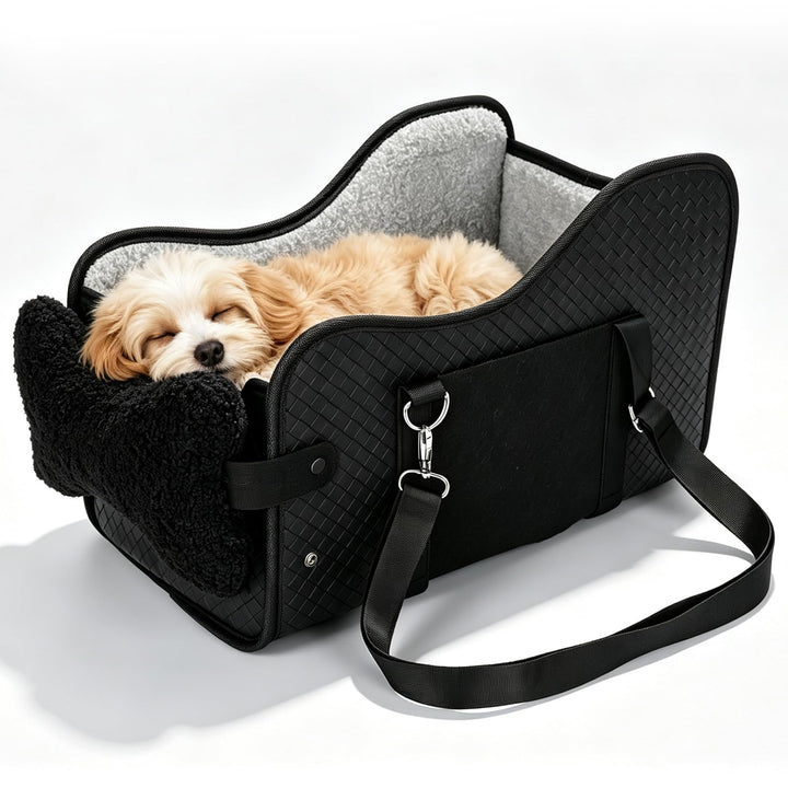 Small dog resting in black pet seat on white background