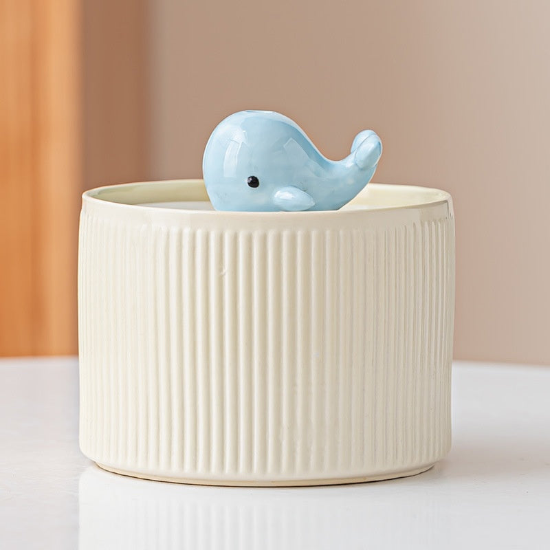 Yellow ribbed fountain with whale centerpiece
