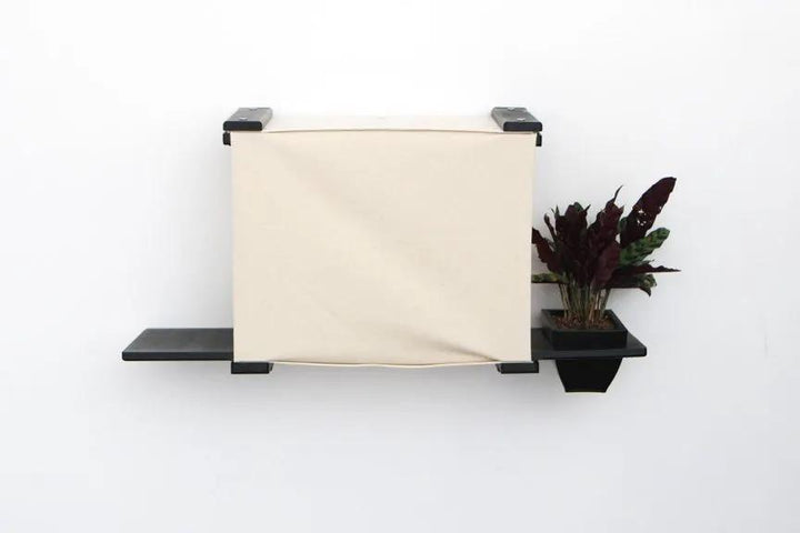 Deluxe Cat Cubby Bed by Catastrophic Creations on a wall-mounted shelf, beige fabric, black frame