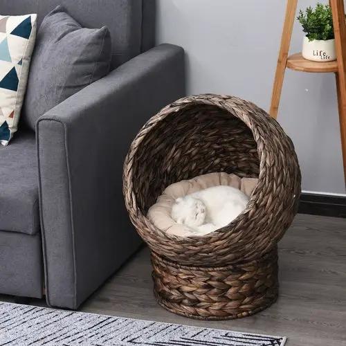 Handmade wicker elevated cat bed with beige cushion in dark brown frame for kittens by Pear Daisy