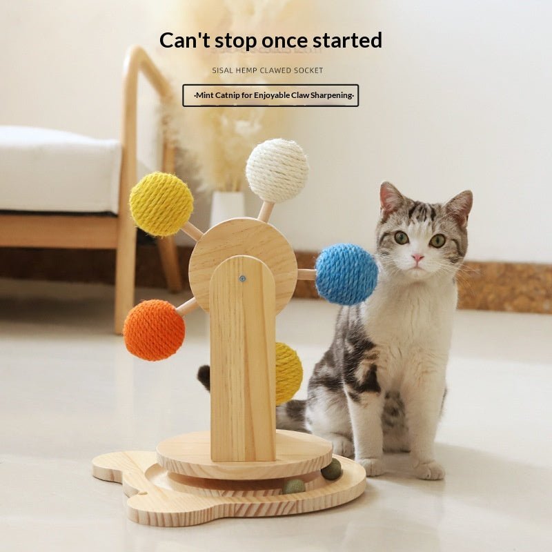 Cat reaching toward turntable rope balls