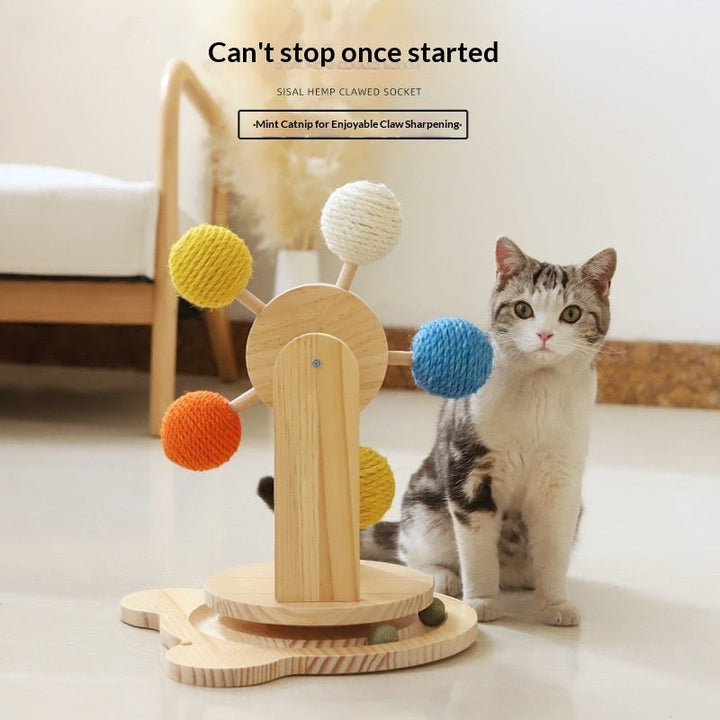Cat reaching toward turntable rope balls