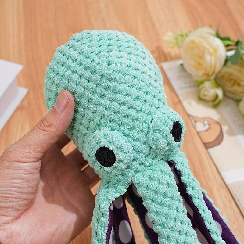 Hand holding plush octopus head