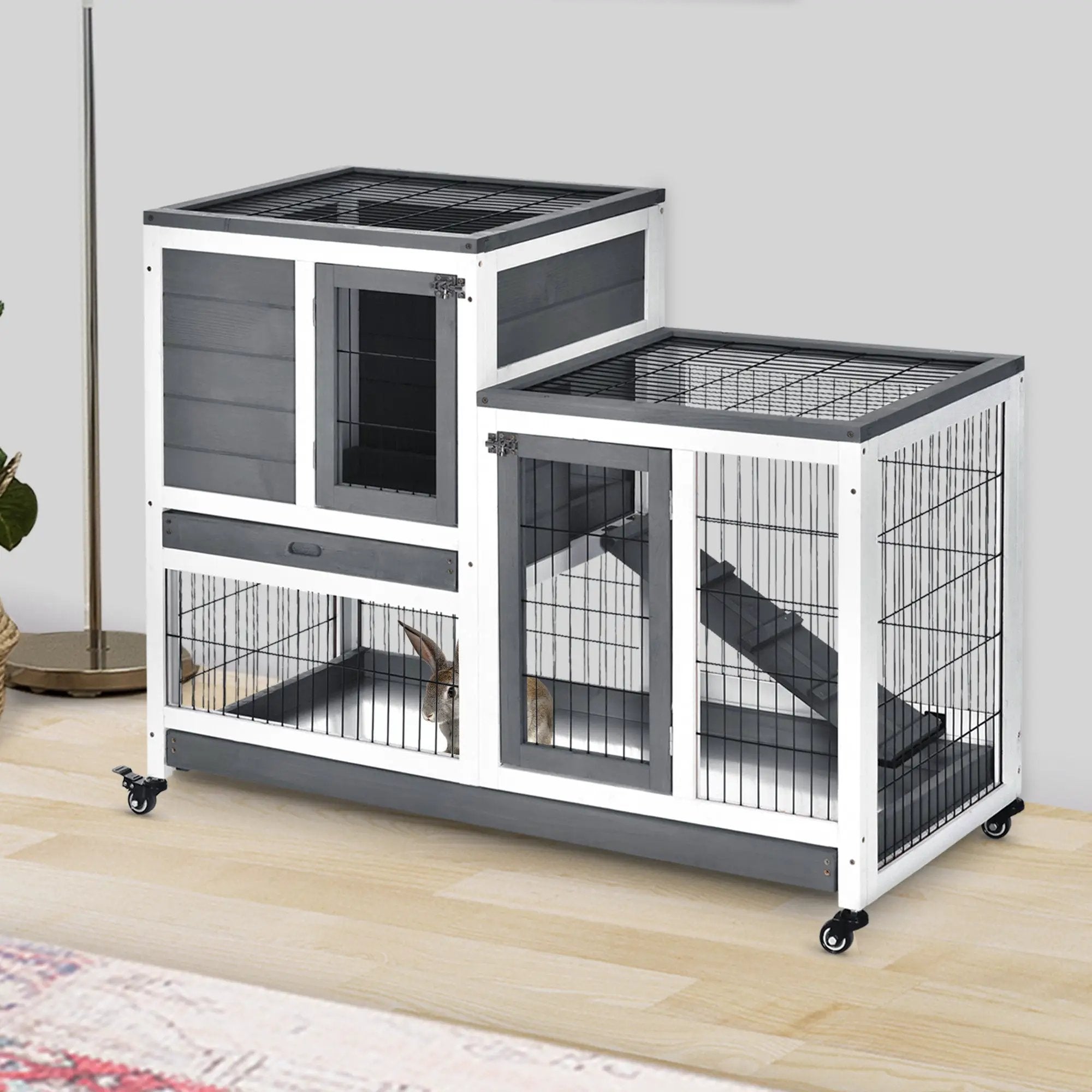 PawHut wooden rabbit hutch with white/gray panels, two-tier cage on casters, rabbit visible inside.