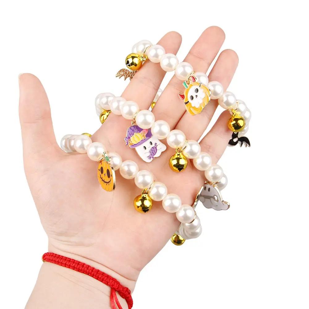 Halloween pet collar with charms featuring glossy pearls and playful gold-tone bells.