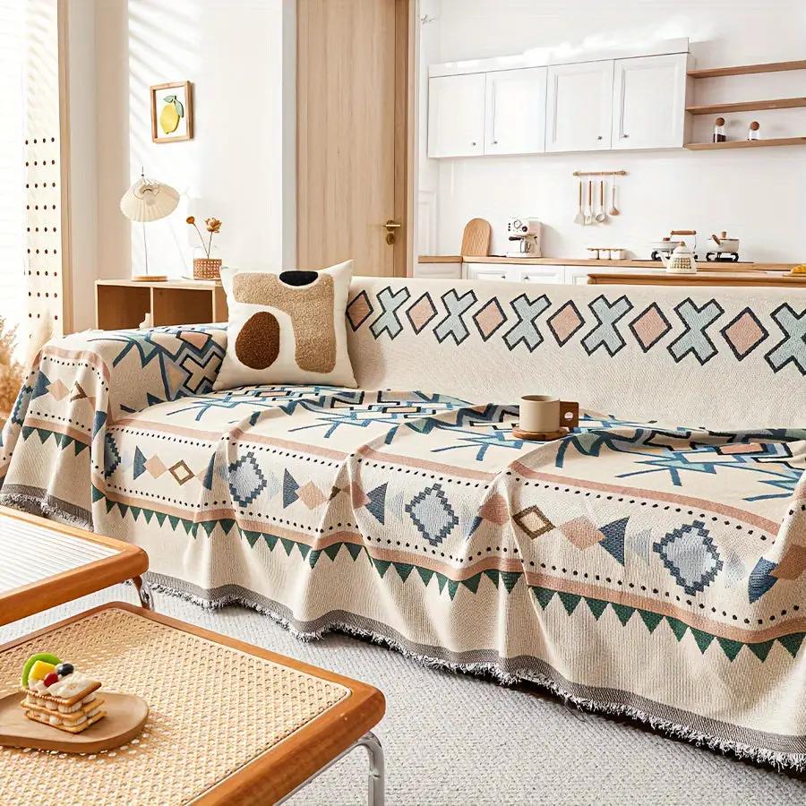 Extra Large Sofa Cover stretchable furniture protector; cream with blue geometric patterns on a sofa.