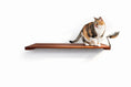 Carica l'immagine nel visualizzatore della galleria, Wall mounted cat feeding shelf by Catastrophic Creations; brown wood shelf with metal bowl, cat perched.
