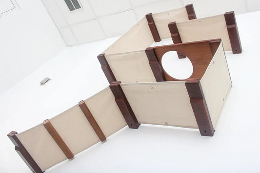 Deluxe Cat Fort Modern Cat Condo by Catastrophic Creations, beige fabric panels with dark brown wood supports.