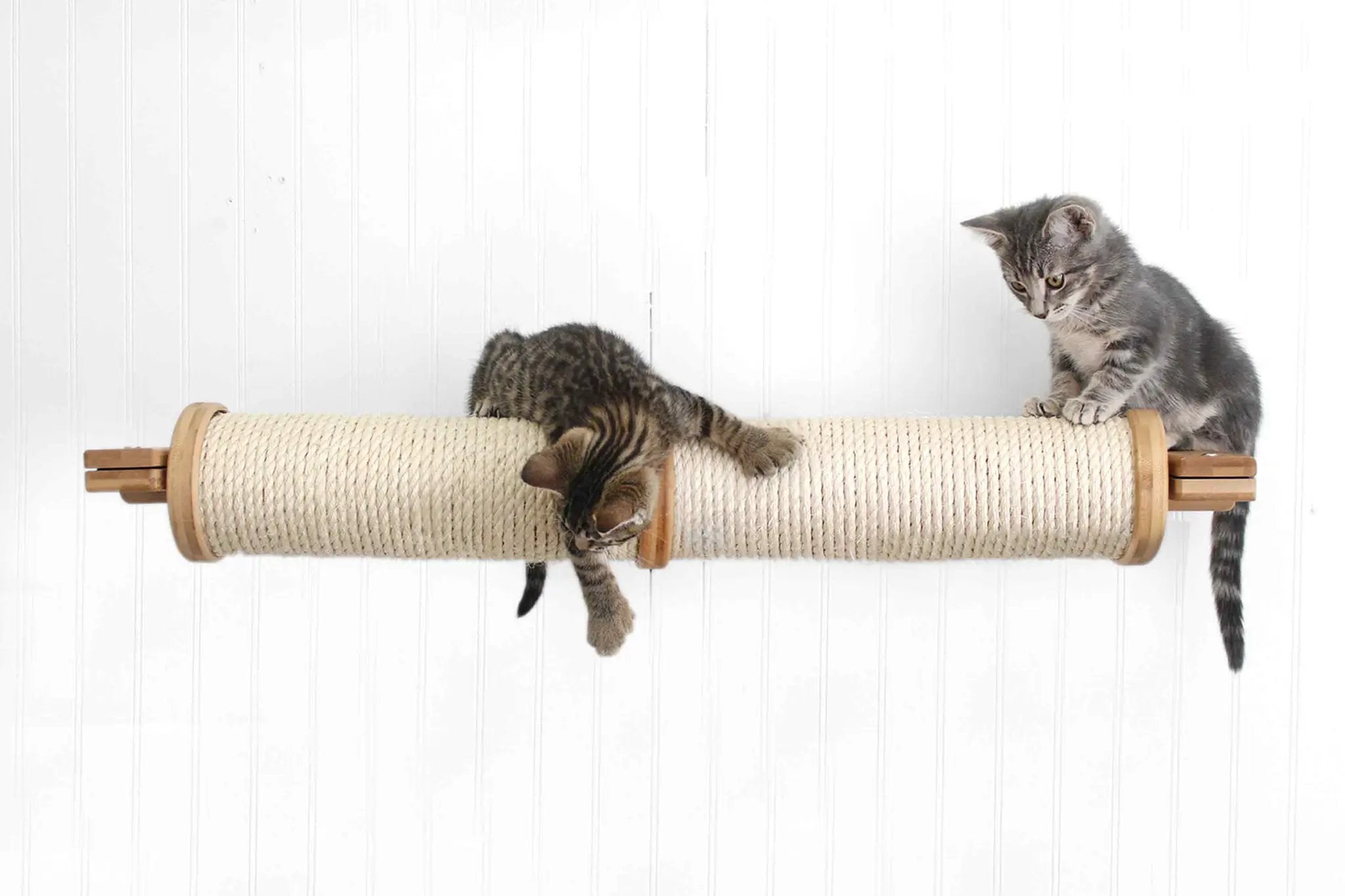Horizontal Scratching Post for Cats with beige sisal rope wrap and wooden ends; two kittens on it