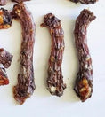 Load image into Gallery viewer, Duck Necks, three dried brown treats with wrinkled texture
