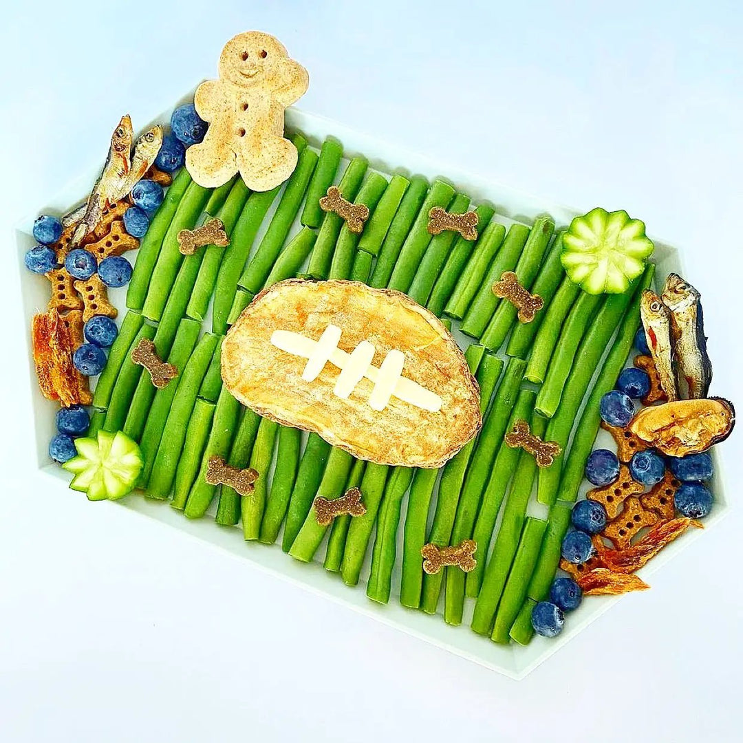 Green Lipped Mussels small animal treats by Naked Beasts on a green veggie platter with bone-shaped bites.