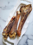 Load image into Gallery viewer, Lamb shanks on a white platter; bone-in, pasture-raised, three pieces.
