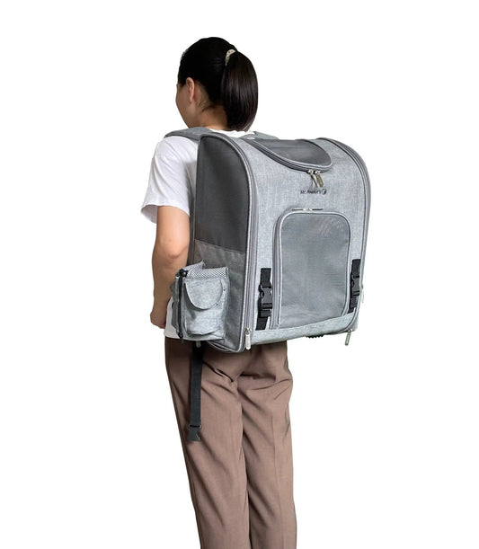 Mr. Peanut's Aspen Series backpack pet carrier in grey fabric, worn on a person's back
