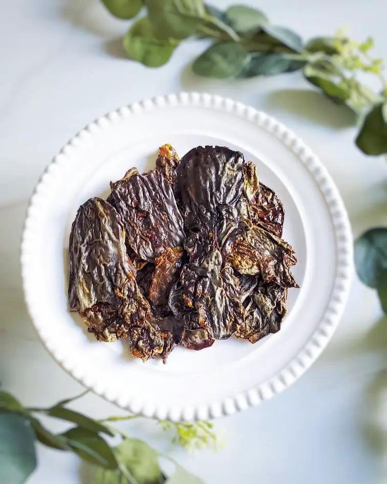 Duck Livers (ABF) by Naked Beasts on a white plate; dark dried liver slices.
