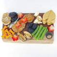 Load image into Gallery viewer, Green Lippped Mussels small animal treats by Naked Beasts on a wooden board with assorted snacks.
