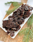 Load image into Gallery viewer, Turkey Heart (Sliced) from Naked Beasts, dark brown dried slices for small animal treats on a white platter
