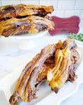 Load image into Gallery viewer, Duck Frames (ABF) by Naked Beasts; stacked golden-brown cooked duck frames on a white platter
