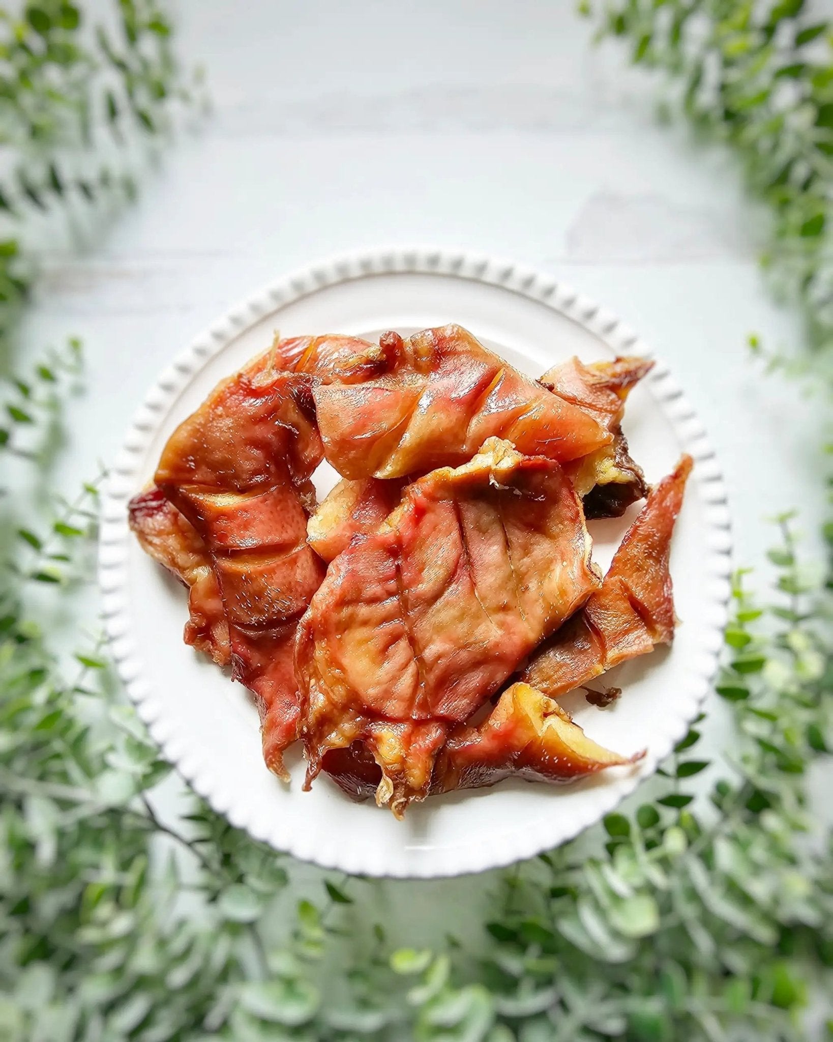 Pig Snout jerky pieces by Naked Beasts on a white plate