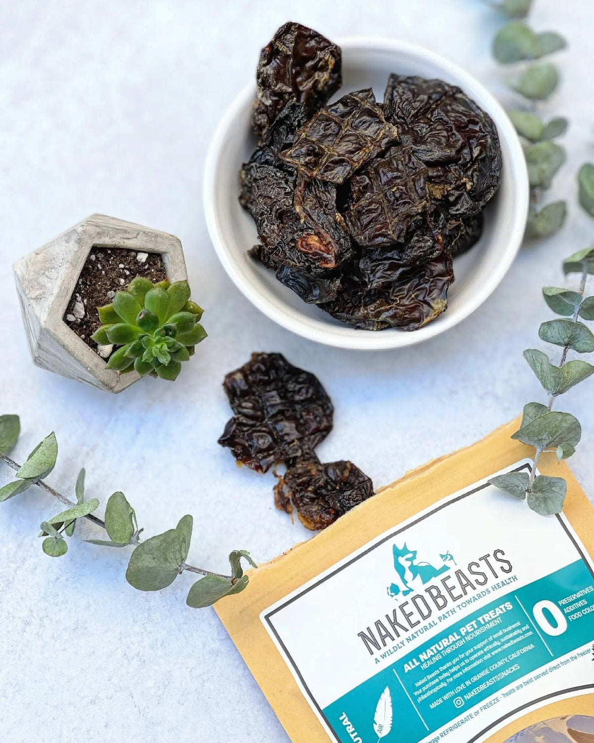 Turkey Liver small animal treats by Naked Beasts in a white bowl with dark dried liver chunks