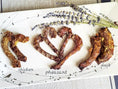 Load image into Gallery viewer, Naked Beasts Duck Necks on white plate with lavender sprigs; includes chicken and pheasant necks
