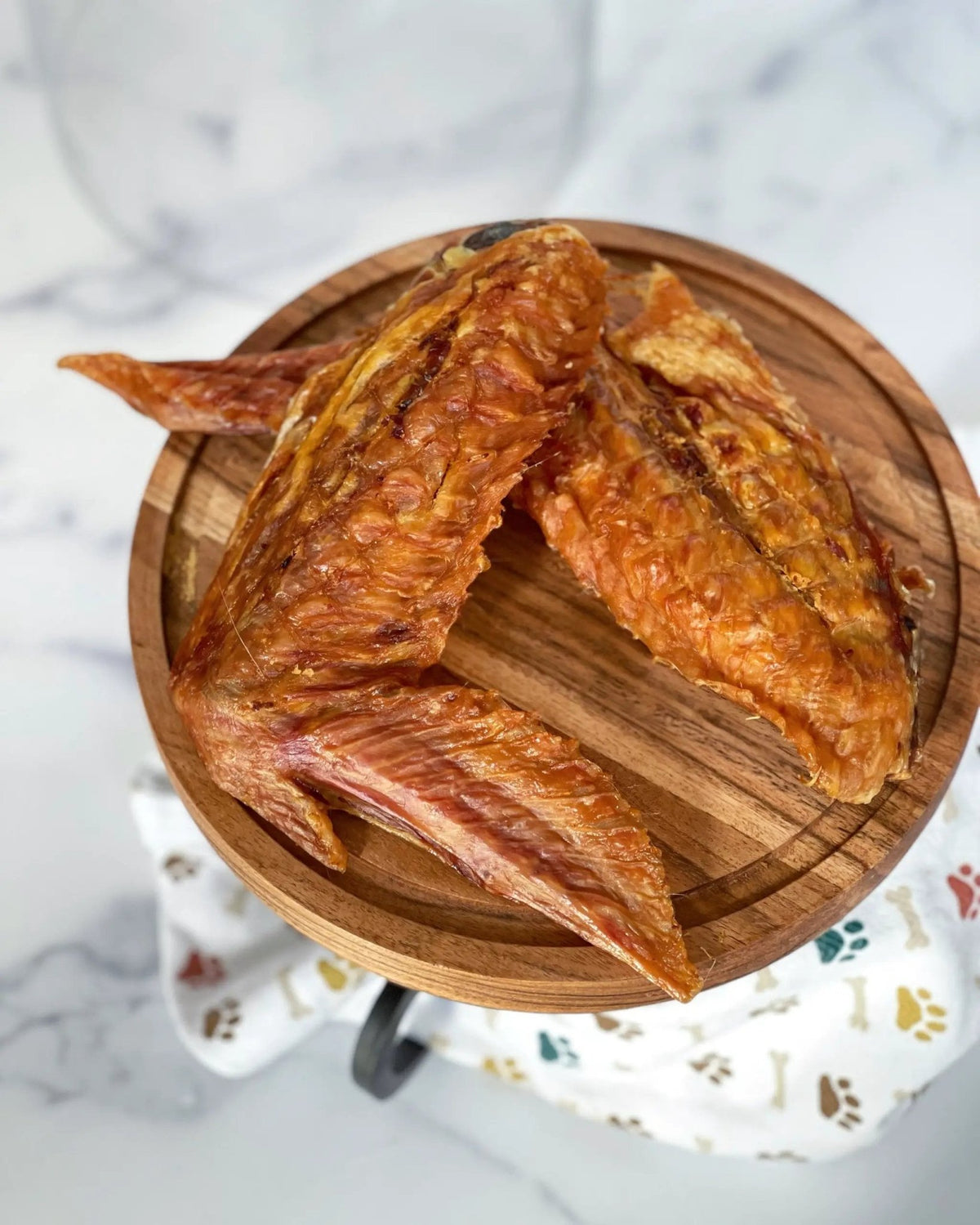 Turkey wings by Naked Beasts, golden-brown and crispy on a wooden board