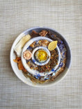 Load image into Gallery viewer, Blue Spirulina Powder (Organic) by Naked Beasts in a ceramic bowl with blue swirls and colorful toppings
