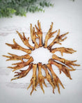 Load image into Gallery viewer, Chicken feet from Naked Beasts; golden brown, multiple feet arranged in a circle on a white wooden surface.
