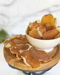 Load image into Gallery viewer, Pork Loin (Fat Trimmed) Thin Cut slices arranged on a wooden board with a white bowl
