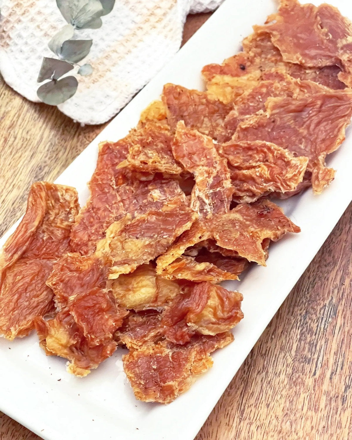Naked Beasts chicken breast thin-cut, fat-trimmed slices on a white platter