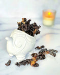 Load image into Gallery viewer, Beef kidney slices (fat trimmed, thin cut) on a white mug, several pieces.

