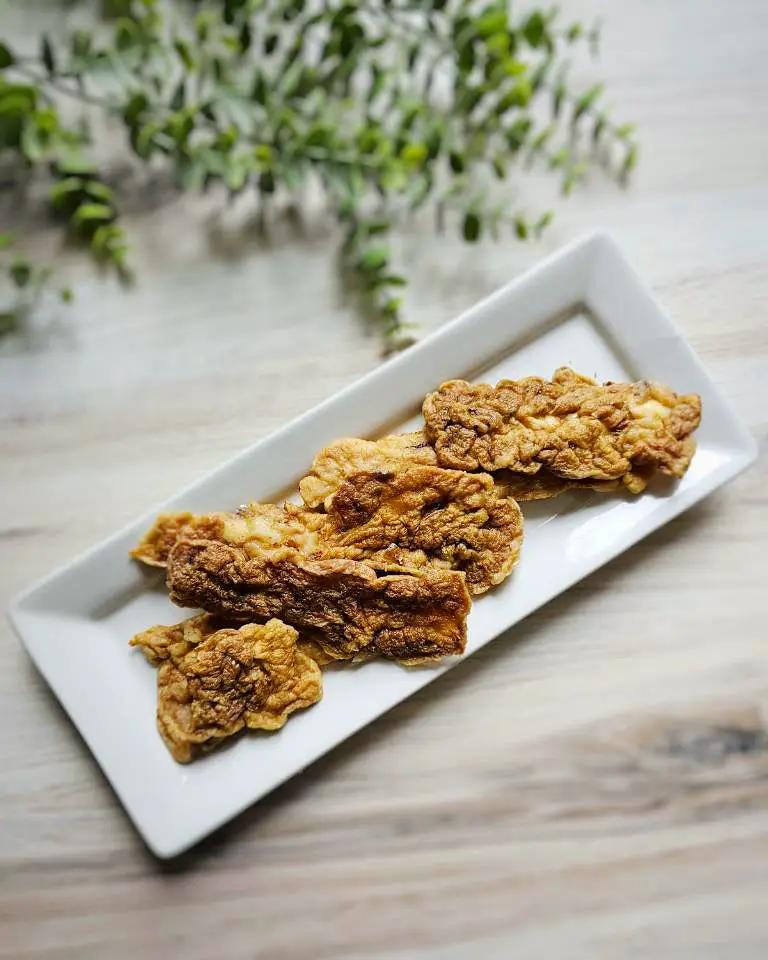 Beef Thymus (Fat Trimmed) from Naked Beasts; five browned fried slices on a white plate.