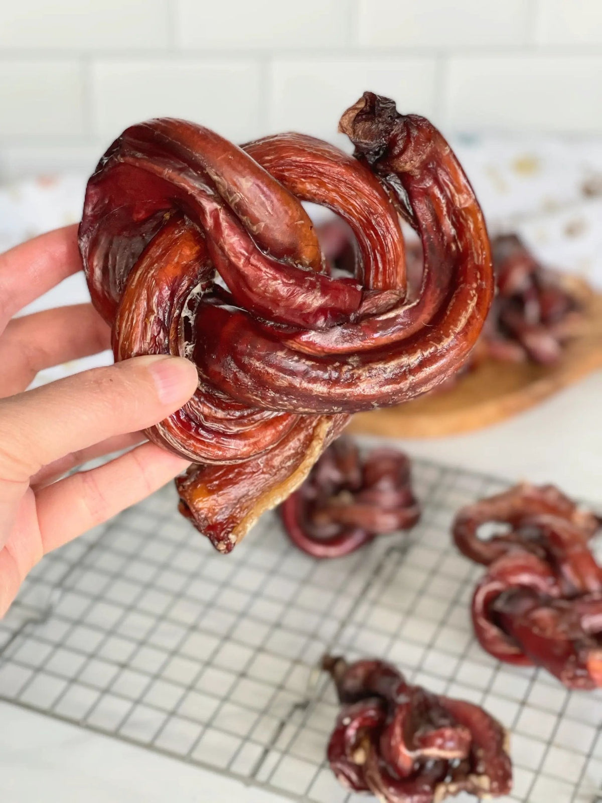 Beef Pizzle loops and sticks by Naked Beasts, Limited Edition; several dark red, twisted chews.