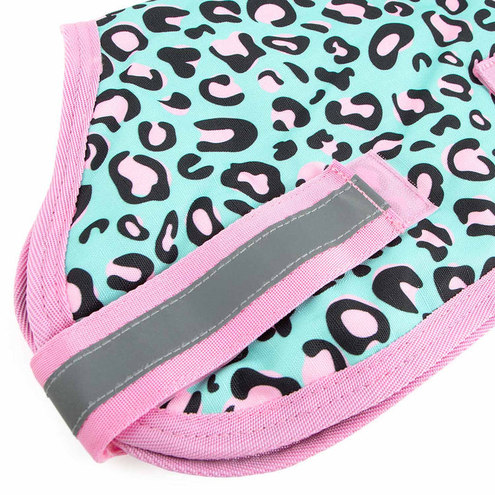 Jeffers Expression 600D waterproof ripstop dog coat; turquoise with pink leopard print, pink trim, gray reflective strap.